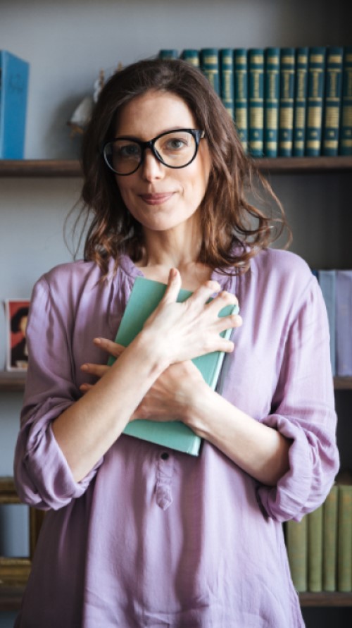 portrait-smiling-mature-woman-glasses-holding-book